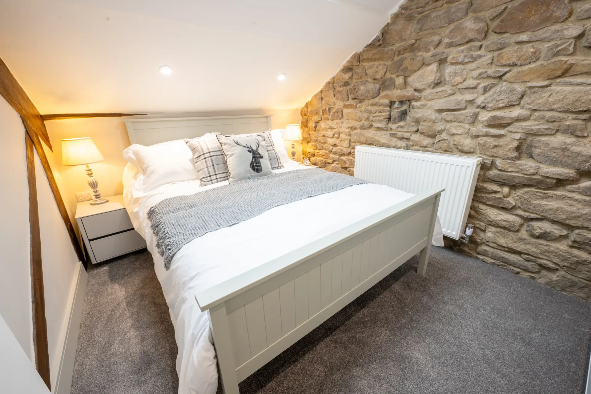 Cozy bedroom with stone wall feature