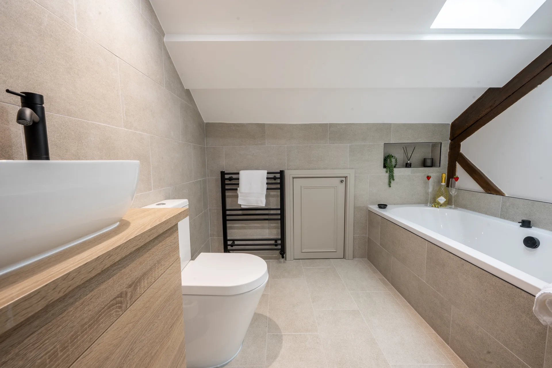 Bathroom with a bathtub, toilet and skylight