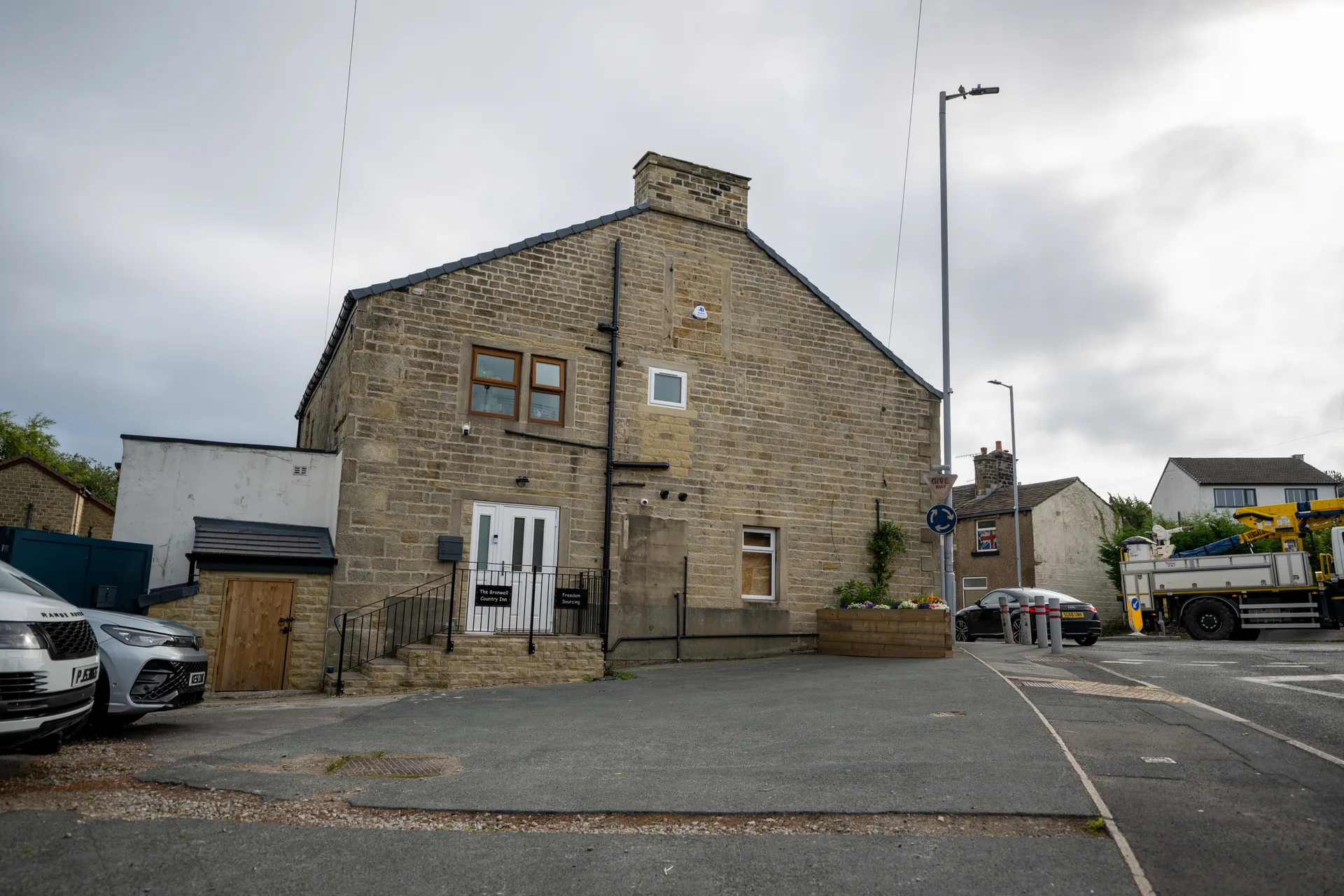Stone exterior of The Branwell Country Inn beside the road